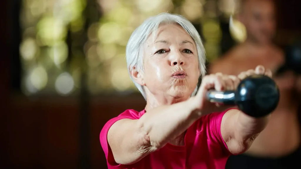 Toning Bingo Wings: Effective Exercises and Tips for Achieving Sleeker Arms 2 Person performing arm exercises with dumbbells Oxted